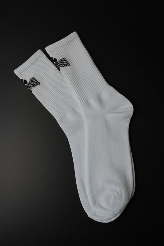 White socks with black logo on a textured black background